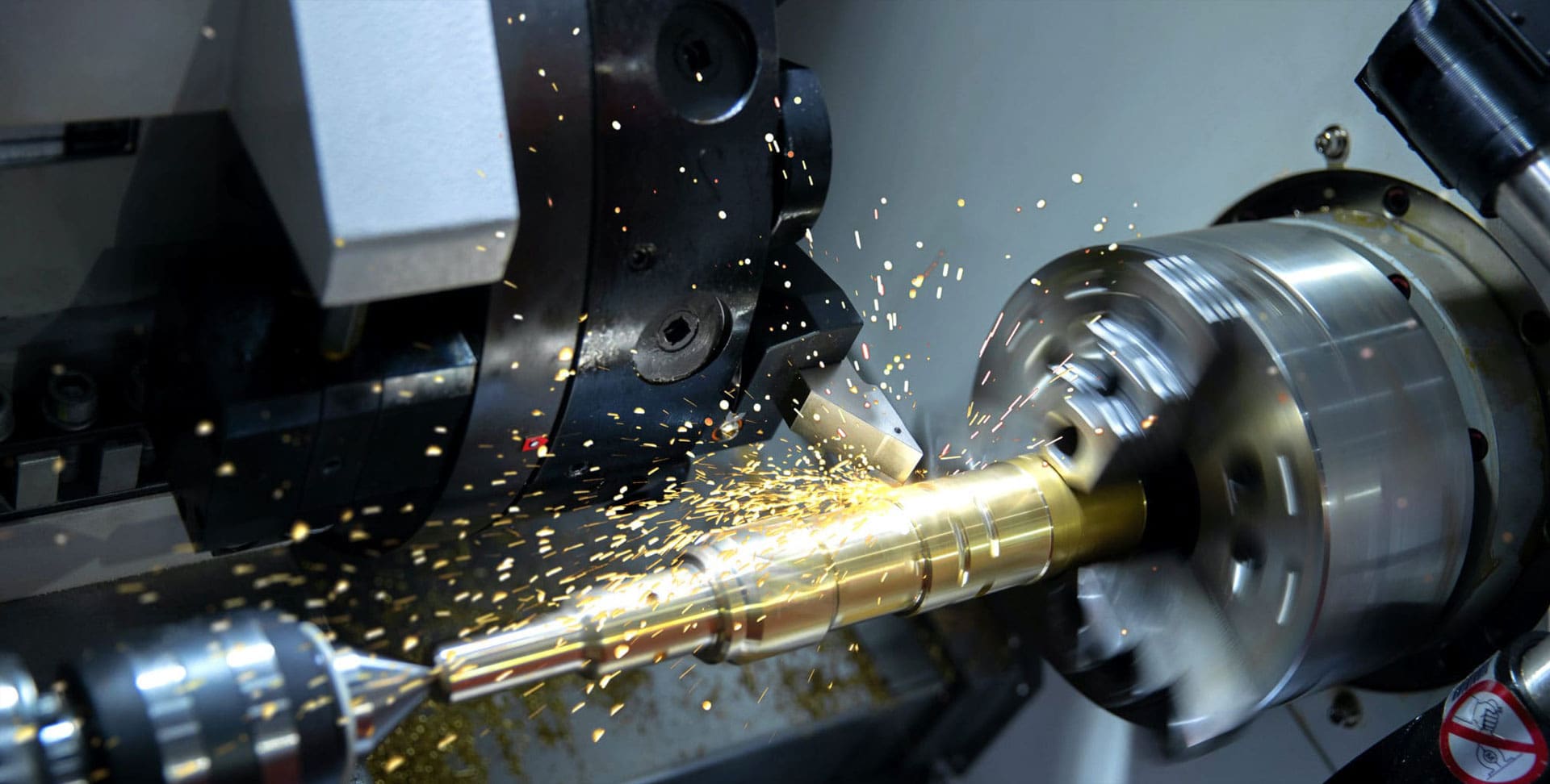 A machine cutting metal with sparks flying from it.