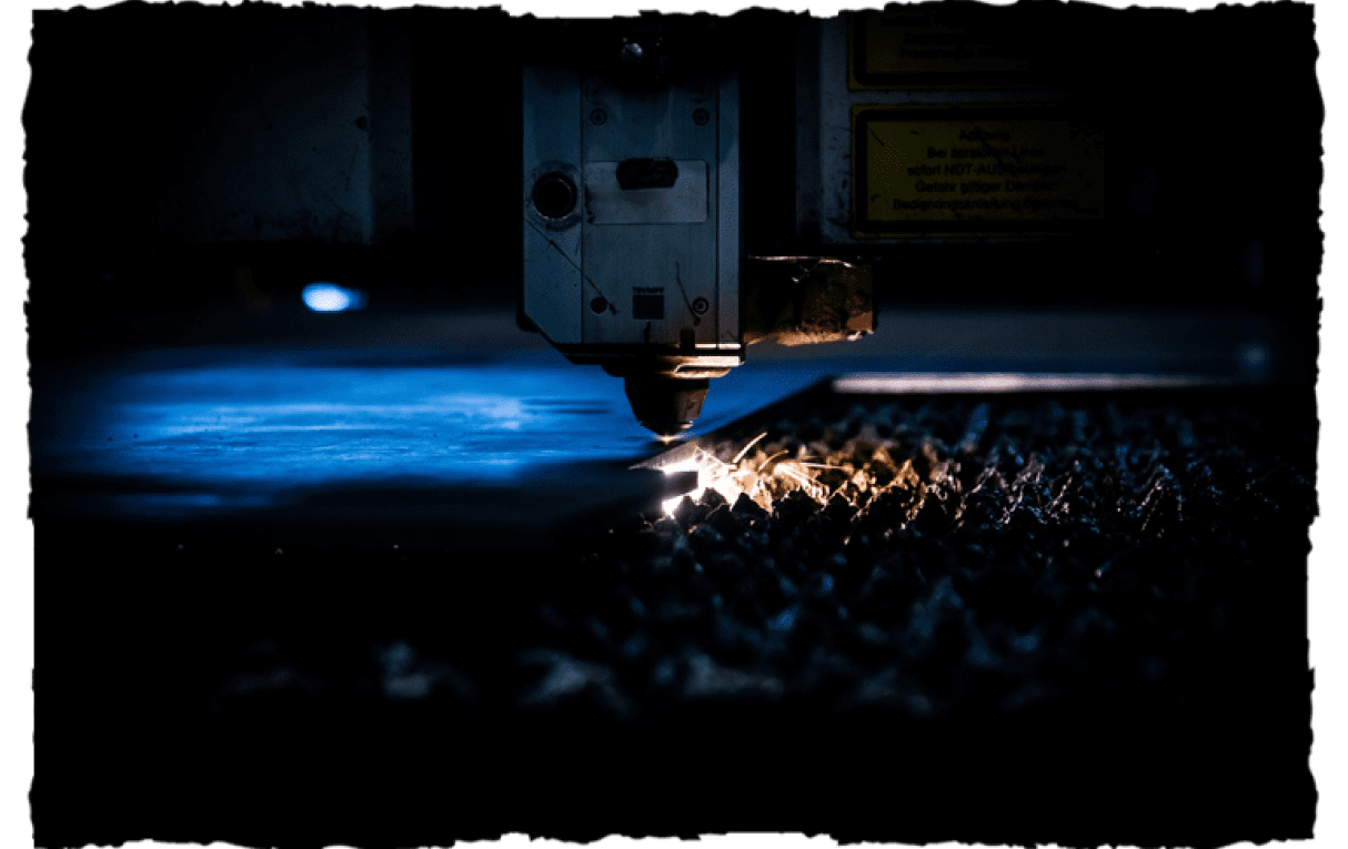 A machine is cutting metal with sparks flying.